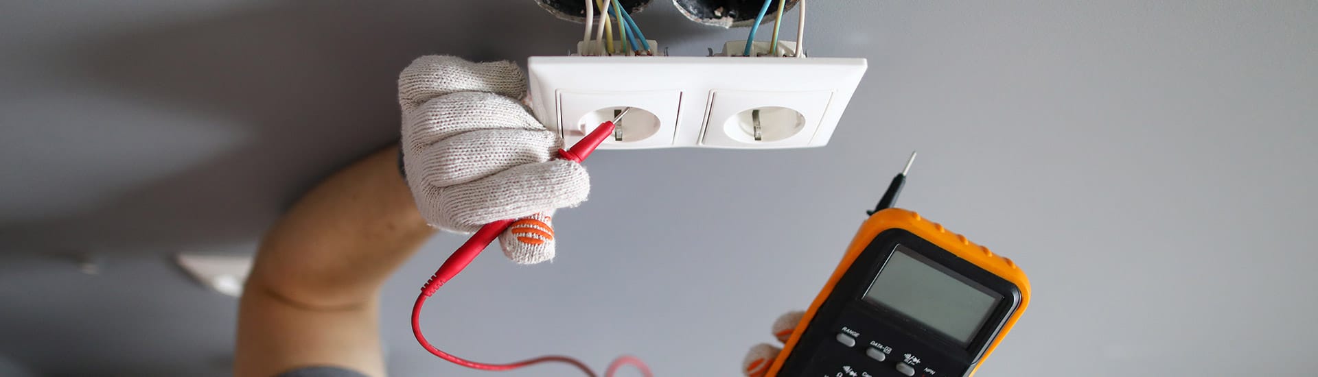 Residential Electrician checking the voltage of an outlet in Dallas